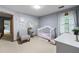Bedroom featuring carpet, light gray walls, a crib, a window, and decorative wall art at 2041 Millspring Nw Way, Kennesaw, GA 30152