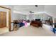 Spacious bonus room with multiple seating areas, natural light, and a ceiling fan at 2041 Millspring Nw Way, Kennesaw, GA 30152