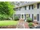 Charming two-story home featuring a symmetrical facade with beautiful lawn and manicured shrubs at 2041 Millspring Nw Way, Kennesaw, GA 30152