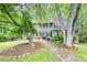 Charming two-story home with stone walkway, beautiful lawn, and mature trees at 2041 Millspring Nw Way, Kennesaw, GA 30152