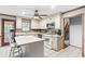 Spacious kitchen featuring an island, white appliances, and light wood trim at 2041 Millspring Nw Way, Kennesaw, GA 30152