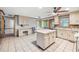 Large kitchen with tile flooring, center island, and a workstation desk area at 2041 Millspring Nw Way, Kennesaw, GA 30152