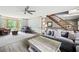 Spacious living room featuring hardwood floors, bay windows, and comfortable seating at 2041 Millspring Nw Way, Kennesaw, GA 30152