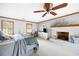 Cozy main bedroom with a brick fireplace, ceiling fan, two windows, and light gray walls at 2041 Millspring Nw Way, Kennesaw, GA 30152