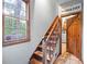 Interior staircase with wooden steps and a window, leading to a doorway and kitchen at 2041 Millspring Nw Way, Kennesaw, GA 30152