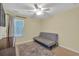 Comfortable bedroom with a futon and a decorative rug on hardwood floors at 3982 Brockenhurst Dr, Buford, GA 30519