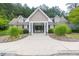 Community clubhouse is beautifully landscaped with a covered entranceway and manicured bushes at 3982 Brockenhurst Dr, Buford, GA 30519
