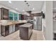 Modern kitchen featuring granite countertops, stainless steel appliances, and dark wood cabinets at 3982 Brockenhurst Dr, Buford, GA 30519
