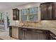 Kitchen featuring stainless steel dishwasher, granite countertops, and a backyard view at 3982 Brockenhurst Dr, Buford, GA 30519