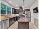 Modern kitchen featuring stainless steel appliances, granite countertops, and a central island at 3982 Brockenhurst Dr, Buford, GA 30519