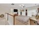 Upstairs living room with a comfortable sofa, TV, and access to the bedrooms at 3982 Brockenhurst Dr, Buford, GA 30519