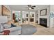 Cozy living room featuring a fireplace, neutral decor, and seamless flow to the kitchen at 3982 Brockenhurst Dr, Buford, GA 30519