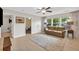 Upstairs living room with TV, neutral decor, and wood-look flooring and a gray rug at 3982 Brockenhurst Dr, Buford, GA 30519