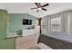 Bright main bedroom with ceiling fan, television, and two large windows at 3982 Brockenhurst Dr, Buford, GA 30519