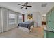 Bright main bedroom with ensuite bathroom, ceiling fan, and two large windows at 3982 Brockenhurst Dr, Buford, GA 30519