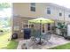 This beautiful outdoor patio has a metal table with chairs and a grill under a bright umbrella at 3982 Brockenhurst Dr, Buford, GA 30519