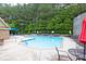 Enjoy the community swimming pool with ample seating surrounded by lush trees in this neighborhood at 3982 Brockenhurst Dr, Buford, GA 30519