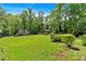 Expansive backyard with lush lawn, mature trees, and a storage shed at 6863 Recreation Ln, Acworth, GA 30102