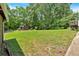 Lush backyard featuring mature trees, a shed, and a wooden deck at 6863 Recreation Ln, Acworth, GA 30102