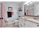 Cozy bathroom with granite vanity, tiled floors, framed mirror, and pink accents at 6863 Recreation Ln, Acworth, GA 30102