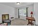 White bedroom with window, gray carpet, furniture and picture frame at 6863 Recreation Ln, Acworth, GA 30102