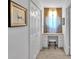 Hallway with vanity, stool, window, drawers, and neutral carpeting at 6863 Recreation Ln, Acworth, GA 30102