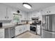 Bright kitchen features stainless steel appliances and ample counter space at 6863 Recreation Ln, Acworth, GA 30102