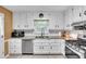 The bright kitchen offers granite counters, modern appliances, and classic white cabinets at 6863 Recreation Ln, Acworth, GA 30102