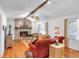 Cozy living room featuring hardwood floors, a brick fireplace, and comfortable seating arrangements at 6863 Recreation Ln, Acworth, GA 30102