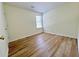 This bedroom features wood-look flooring and a sunlit window at 2130 Chattahoochee Dr, Duluth, GA 30097