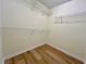 Walk-in closet with wood-look flooring and wire shelving at 2130 Chattahoochee Dr, Duluth, GA 30097