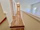 Upstairs hallway featuring wood flooring and natural light from a window at 2130 Chattahoochee Dr, Duluth, GA 30097