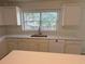 Well-lit kitchen with white cabinetry, countertops, and stainless steel sink at 2130 Chattahoochee Dr, Duluth, GA 30097