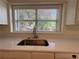 Kitchen detail featuring quartz countertops and stainless steel faucet fixture at 2130 Chattahoochee Dr, Duluth, GA 30097