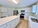 Modern kitchen featuring white cabinets, stainless steel appliances and a large center island at 2130 Chattahoochee Dr, Duluth, GA 30097