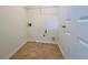 This laundry room is equipped with hookups and ceramic tile flooring at 2130 Chattahoochee Dr, Duluth, GA 30097