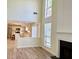 Comfortable living room featuring a fireplace, large windows and an open floorplan to the kitchen at 2130 Chattahoochee Dr, Duluth, GA 30097