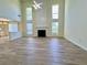 Large living room featuring soaring ceilings, a cozy fireplace, and natural light at 2130 Chattahoochee Dr, Duluth, GA 30097