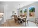 Bright dining room with natural light, a modern chandelier, and views of the outdoors at 302 Bunker Hill Ct, Acworth, GA 30102
