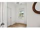 Bright entryway with a door, light hardwood floors, and white walls at 302 Bunker Hill Ct, Acworth, GA 30102