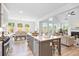 Gourmet kitchen with a large island, stainless steel appliances, and a view into the bright living room and dining space at 302 Bunker Hill Ct, Acworth, GA 30102