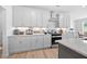 Contemporary kitchen features white cabinets, modern appliances, and ample countertop space for cooking at 302 Bunker Hill Ct, Acworth, GA 30102