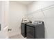 Well-lit laundry room with modern washer and dryer and wire shelving at 302 Bunker Hill Ct, Acworth, GA 30102