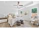 Bright main bedroom with tray ceiling, fan, and backyard view at 302 Bunker Hill Ct, Acworth, GA 30102