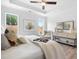 Bright main bedroom with tray ceiling, fan, and wooded view at 302 Bunker Hill Ct, Acworth, GA 30102