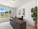 Bright office space with a large desk, neutral carpet, and large windows at 302 Bunker Hill Ct, Acworth, GA 30102
