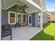 Covered patio with seating area, ceiling fan, and views of the backyard at 302 Bunker Hill Ct, Acworth, GA 30102