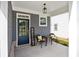 Inviting front porch area featuring seating, decor and a 'Welcome' sign at 302 Bunker Hill Ct, Acworth, GA 30102