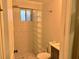 This bathroom features a tiled shower with glass block wall, toilet and sink at 375 6Th Ne St # 5, Atlanta, GA 30308