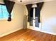 Bright bedroom featuring hardwood floors, neutral walls, and French doors with access to the outdoors at 375 6Th Ne St # 5, Atlanta, GA 30308